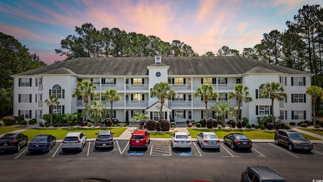 property at dusk with uncovered parking