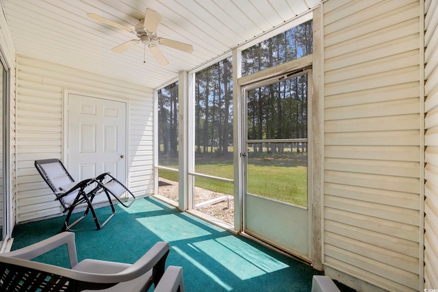 sunroom / solarium featuring a ceiling fan and healthy amount of natural light