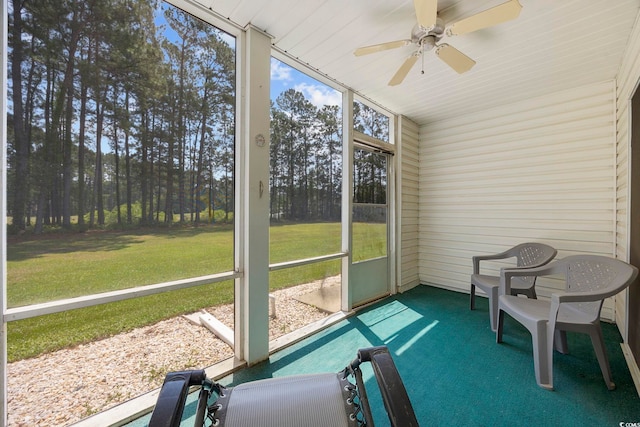 sunroom featuring a ceiling fan