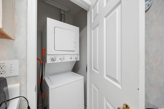 laundry room with stacked washing machine and dryer