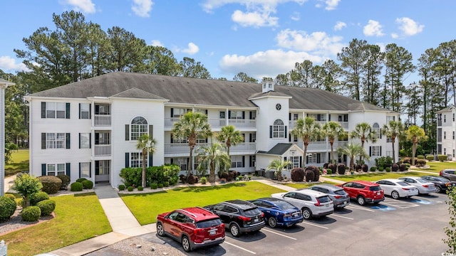 view of building exterior with uncovered parking