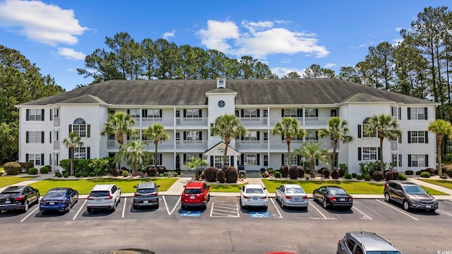 view of building exterior featuring uncovered parking