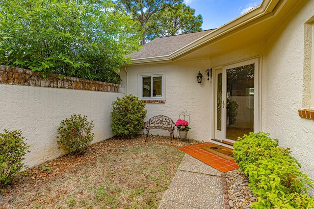 8 Martinique Dr, Myrtle Beach, SC 29572 - doorway to property featuring stucco siding and roof with shingles