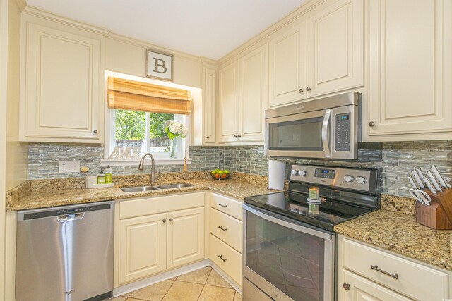 8 Martinique Dr, Myrtle Beach, SC 29572 - kitchen with appliances with stainless steel finishes, a sink, light tile patterned floors, and tasteful backsplash