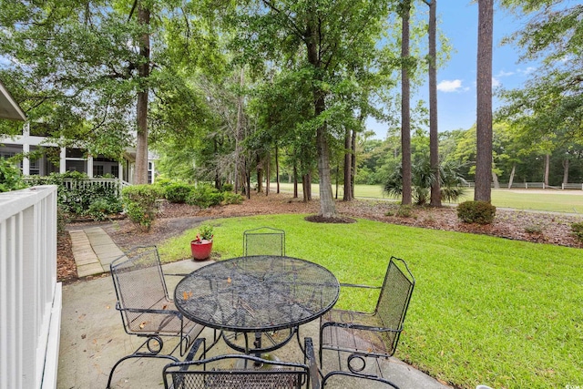 4803 Bucks Bluff Dr, North Myrtle Beach, SC 29582 - view of patio with outdoor dining space and view of wooded area