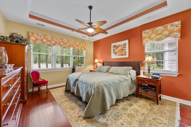 4803 Bucks Bluff Dr, North Myrtle Beach, SC 29582 - bedroom featuring a tray ceiling, multiple windows, baseboards, ornamental molding, and hardwood / wood-style floors