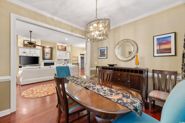 4803 Bucks Bluff Dr, North Myrtle Beach, SC 29582 - dining room featuring wood finished floors, a chandelier, ornamental molding, and baseboards