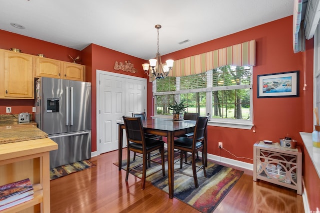 4803 Bucks Bluff Dr, North Myrtle Beach, SC 29582 - dining area featuring a chandelier, wood finished floors, and baseboards