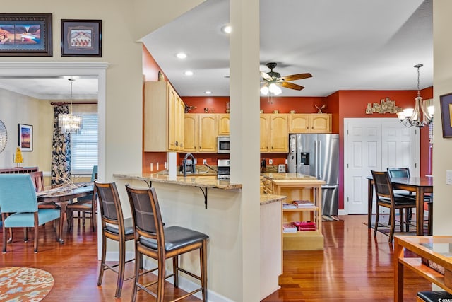 4803 Bucks Bluff Dr, North Myrtle Beach, SC 29582 - kitchen with a chandelier, appliances with stainless steel finishes, dark wood finished floors, a peninsula, and crown molding