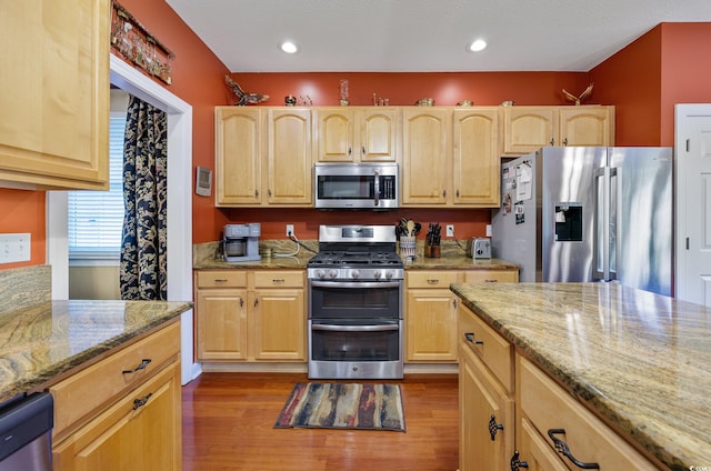 4803 Bucks Bluff Dr, North Myrtle Beach, SC 29582 - kitchen with stainless steel appliances, light brown cabinets, dark wood-type flooring, light stone countertops, and recessed lighting