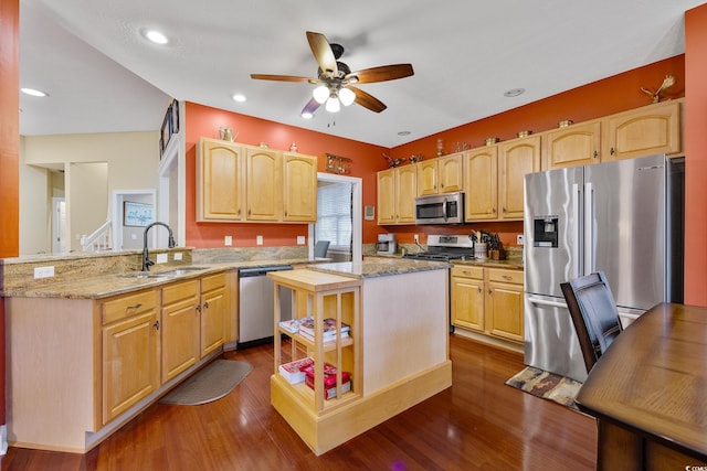 4803 Bucks Bluff Dr, North Myrtle Beach, SC 29582 - kitchen with appliances with stainless steel finishes, a sink, a peninsula, ceiling fan, and light stone countertops