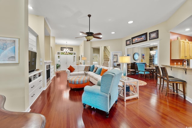 4803 Bucks Bluff Dr, North Myrtle Beach, SC 29582 - living room featuring wood finished floors, stairway, a fireplace, recessed lighting, and a chandelier