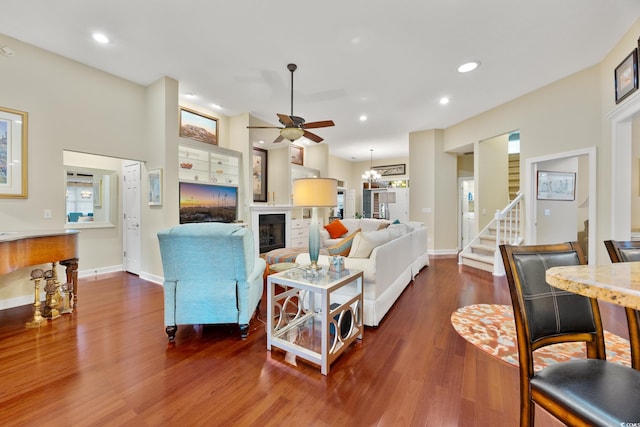 4803 Bucks Bluff Dr, North Myrtle Beach, SC 29582 - living room featuring a ceiling fan, wood finished floors, stairs, recessed lighting, and a glass covered fireplace