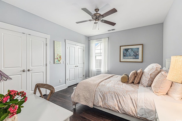 5032 Middleton View Dr, Myrtle Beach, SC 29579 - bedroom with two closets, dark wood-style flooring, ceiling fan, and baseboards