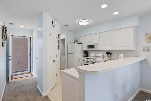 633 Waterway Village Blvd Unit 11D, Myrtle Beach, SC 29579 - kitchen featuring white appliances, light countertops, a peninsula, white cabinetry, and recessed lighting