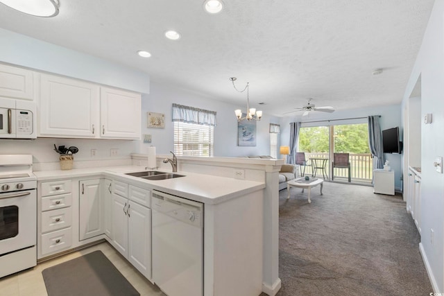 633 Waterway Village Blvd Unit 11D, Myrtle Beach, SC 29579 - kitchen with white appliances, a sink, recessed lighting, a peninsula, and white cabinetry