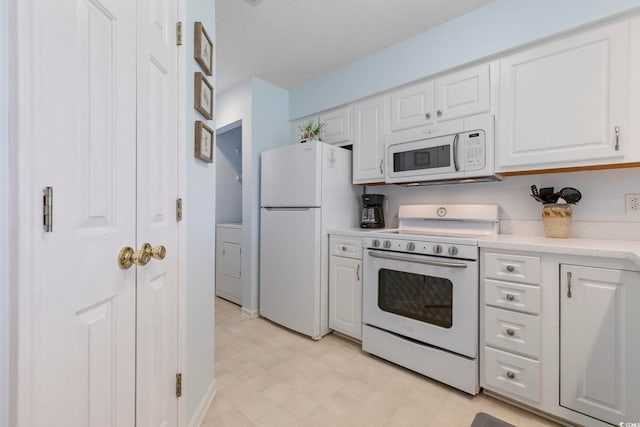 633 Waterway Village Blvd Unit 11D, Myrtle Beach, SC 29579 - kitchen with white appliances, light countertops, white cabinets, washer / dryer, and light floors