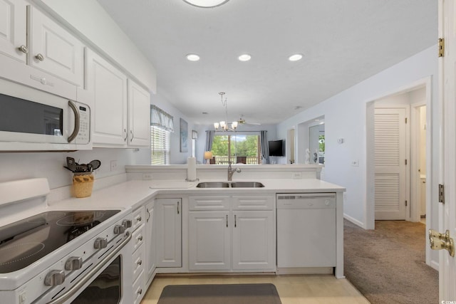 633 Waterway Village Blvd Unit 11D, Myrtle Beach, SC 29579 - kitchen featuring white appliances, recessed lighting, white cabinets, a sink, and a peninsula