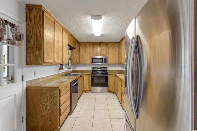 2519 Reta St, Conway, SC 29526 - kitchen featuring stainless steel appliances, a textured ceiling, light tile patterned flooring, a sink, and light countertops