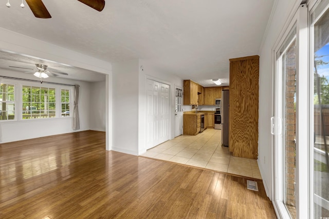 2519 Reta St, Conway, SC 29526 - unfurnished living room with ceiling fan, light wood-style floors, and baseboards