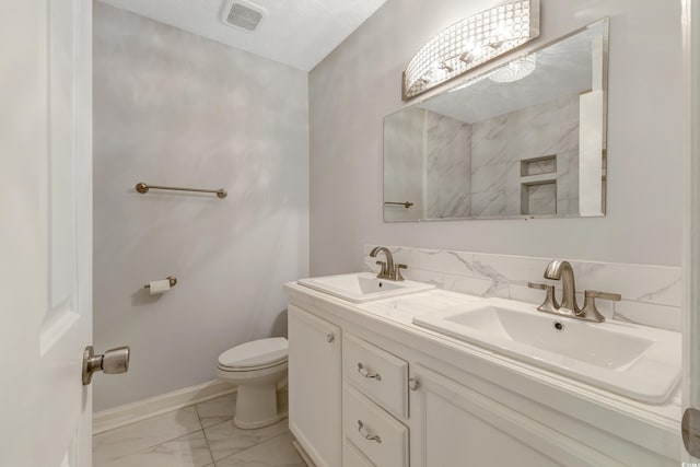 2519 Reta St, Conway, SC 29526 - full bath with marble look tile flooring, double vanity, toilet, and baseboards