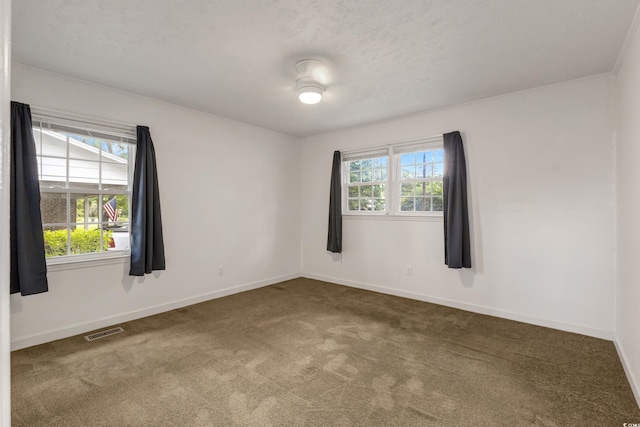 carpeted spare room with baseboards