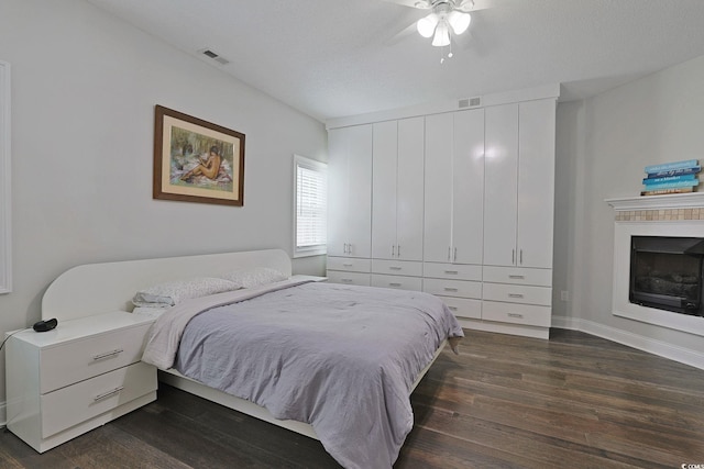 867 Cardinal Pl, North Myrtle Beach, SC 29582 - bedroom featuring dark wood-type flooring, a fireplace, ceiling fan, and baseboards