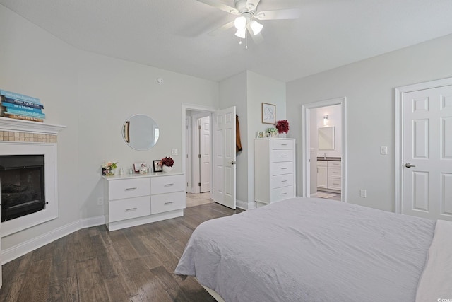 867 Cardinal Pl, North Myrtle Beach, SC 29582 - bedroom with dark wood finished floors, a fireplace, baseboards, ensuite bath, and a ceiling fan