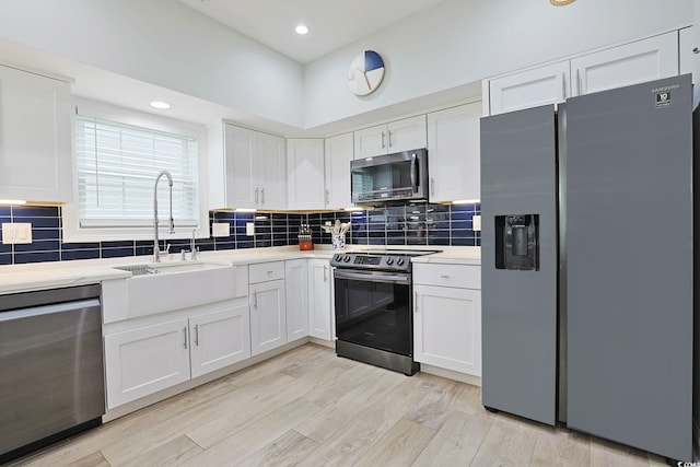 867 Cardinal Pl, North Myrtle Beach, SC 29582 - kitchen featuring appliances with stainless steel finishes, a sink, light countertops, white cabinets, and recessed lighting