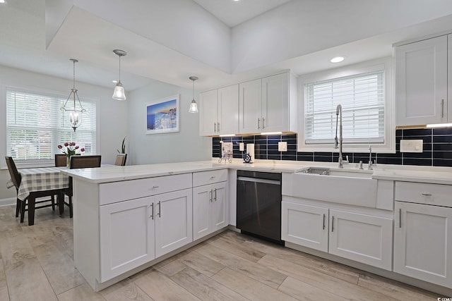 867 Cardinal Pl, North Myrtle Beach, SC 29582 - kitchen featuring dishwasher, a peninsula, white cabinetry, a sink, and light wood-style floors
