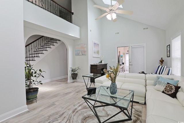 867 Cardinal Pl, North Myrtle Beach, SC 29582 - living room with arched walkways, high vaulted ceiling, wood finished floors, baseboards, and a ceiling fan