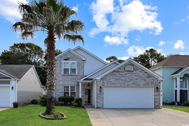 867 Cardinal Pl, North Myrtle Beach, SC 29582 - traditional-style home featuring brick siding, an attached garage, driveway, and a front yard