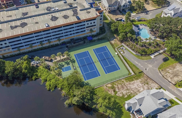 aerial view of property and surrounding area featuring a large body of water and a pool