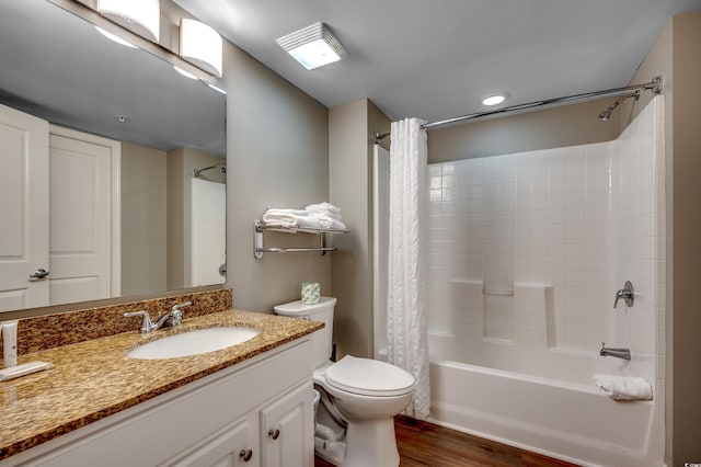 full bath with wood finished floors, shower / tub combo, vanity, and toilet