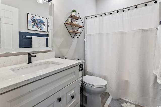 bathroom featuring toilet and vanity