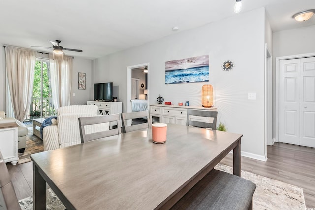 dining room featuring ceiling fan and wood finished floors