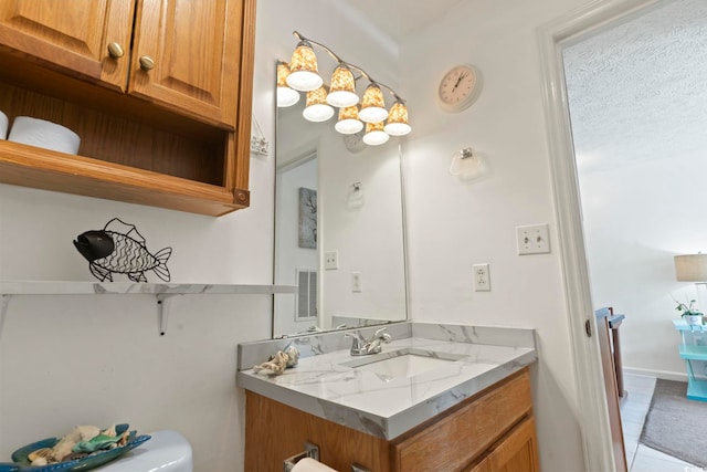 bathroom featuring vanity, toilet, and tile patterned flooring