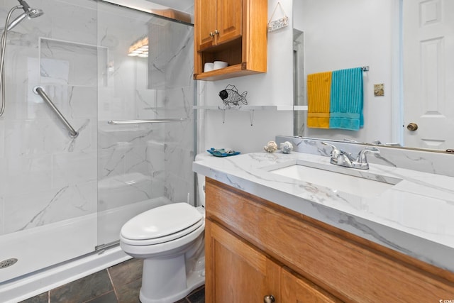 bathroom with a marble finish shower, toilet, and vanity