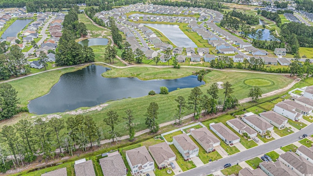 aerial view of property and surrounding area featuring nearby suburban area and a nearby body of water