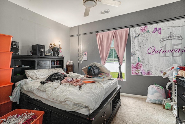 carpeted bedroom with ceiling fan and baseboards