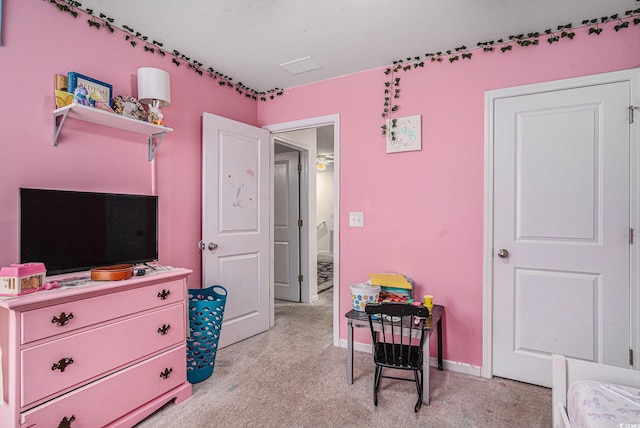 bedroom featuring light carpet and baseboards