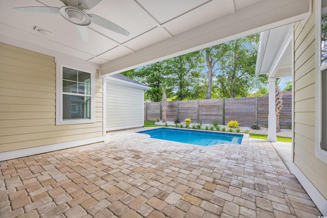view of swimming pool featuring ceiling fan, a patio area, and a fenced backyard