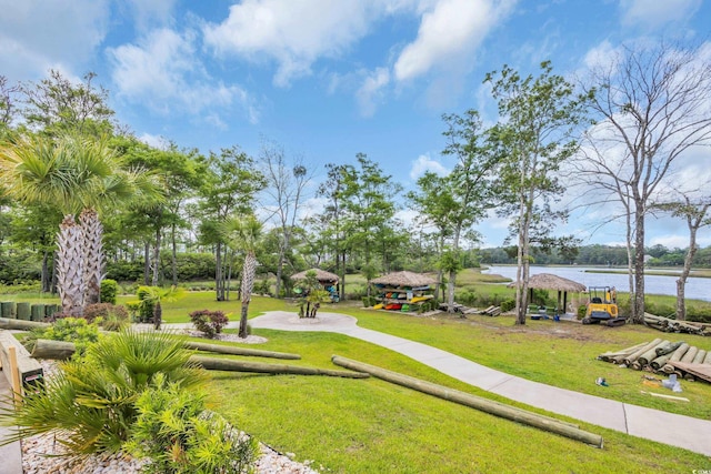 view of community with a water view and a yard