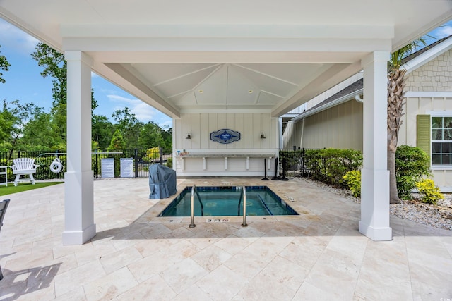 view of swimming pool featuring fence and a patio area