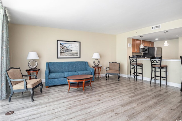 201 S Ocean Blvd Unit 1112, Myrtle Beach, SC 29577 - living room with light wood-style flooring and baseboards