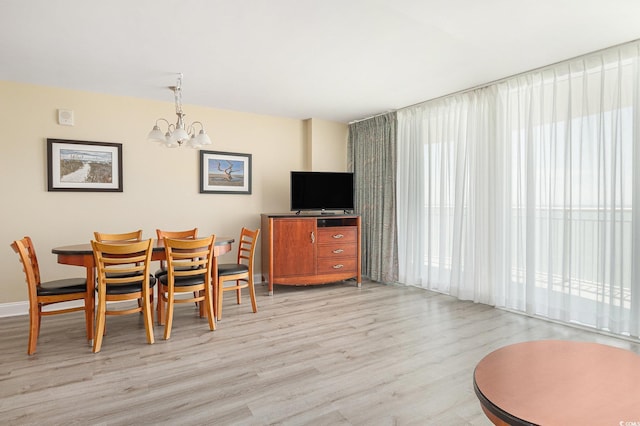 201 S Ocean Blvd Unit 1112, Myrtle Beach, SC 29577 - dining space featuring wood finished floors, a chandelier, and baseboards