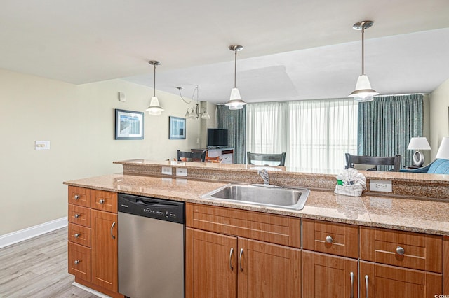 201 S Ocean Blvd Unit 1112, Myrtle Beach, SC 29577 - kitchen with stainless steel dishwasher, a sink, open floor plan, and light wood-style flooring