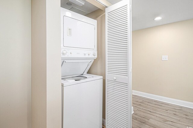 201 S Ocean Blvd Unit 1112, Myrtle Beach, SC 29577 - washroom with estacked washer and dryer, wood finished floors, and baseboards