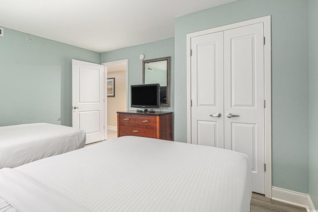 201 S Ocean Blvd Unit 1112, Myrtle Beach, SC 29577 - bedroom with wood finished floors, a closet, and baseboards