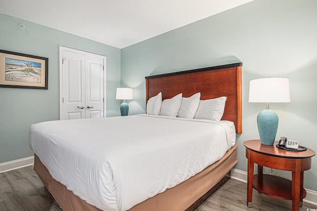 201 S Ocean Blvd Unit 1112, Myrtle Beach, SC 29577 - bedroom with wood finished floors, baseboards, and a closet